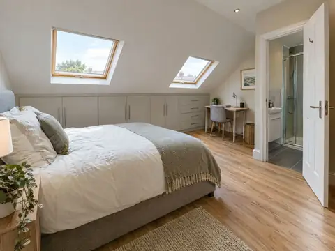 Loft bedroom with two roof windows, built-in eaves storage and an en-suite
