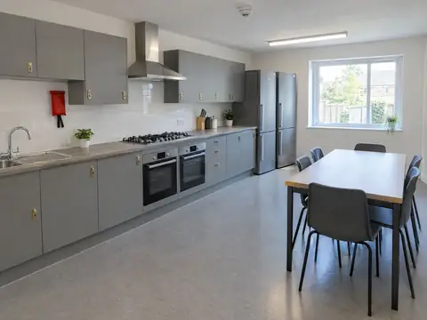 Communal HMO kitchen with two ovens, two fridge-freezers and lockable cupboards