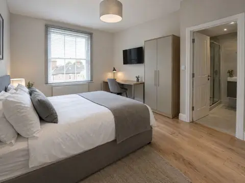 Furnished HMO double bedroom with desk, wardrobe and en-suite